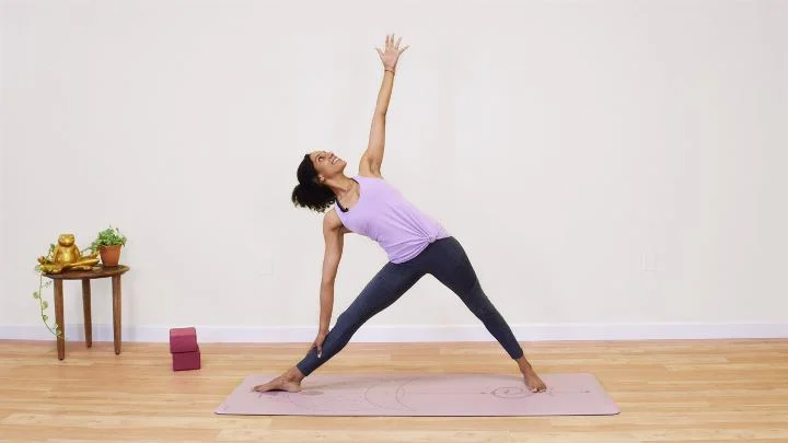 Laia Bove in triangle pose in a yoga class